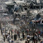 Palestinians collect aid supplies from trucks that entered Gaza, amid a ceasefire between Israel and Hamas, in Khan Younis, in the southern Gaza Strip October 12, 2025.