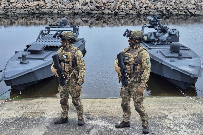 Servicemen of Ukraine's Security Service (SBU) stand guard near the latest versions of its "sea baby" naval drone, amid Russia's attack on Ukraine, in an undisclosed location in Ukraine October 17, 2025. REUTERS/Vlad Smilianets