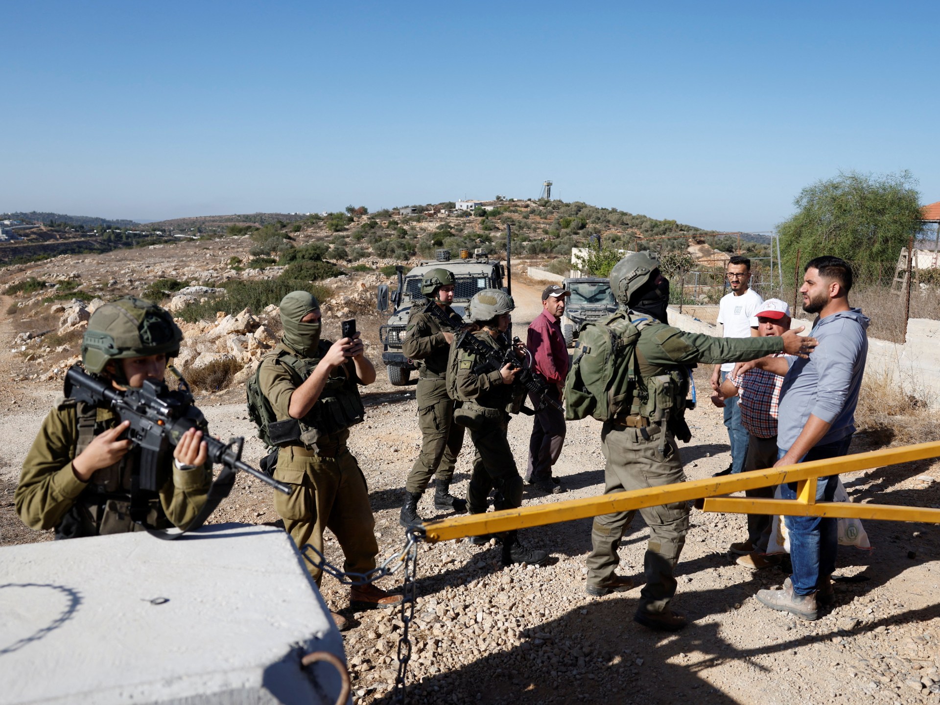 ‘Armed, dangerous’: Israeli settlers attack Palestinians harvesting olives