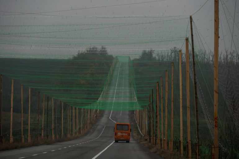A car drives along a road covered with an anti-drone net, amid Russia's attack on Ukraine, near the town of Sloviansk in Donetsk region, Ukraine October 27, 2025. REUTERS/Sofiia Gatilova TPX IMAGES OF THE DAY