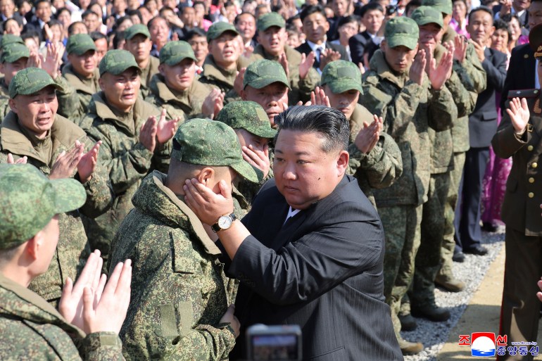 North Korean leader Kim Jong Un (C) encouraging soldiers.