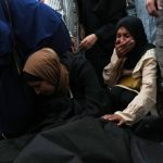 Woman covers her mouth in mourning