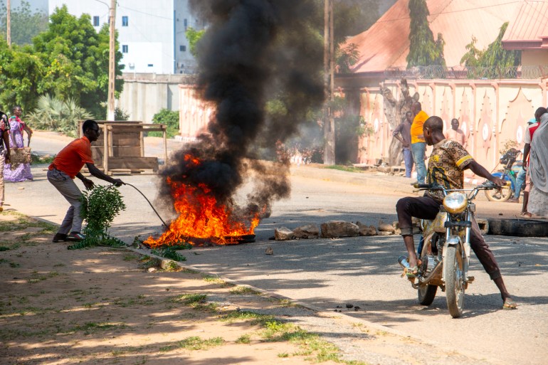 Burning barricades are seen in Garoua during a demonstration by supporters of the political opposition on October 21, 2025 ahead of the release of the results of the presidential vote. (Photo by AFP)