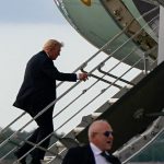 Trump boards Air Force One using small stairs after sniper nest found near airport