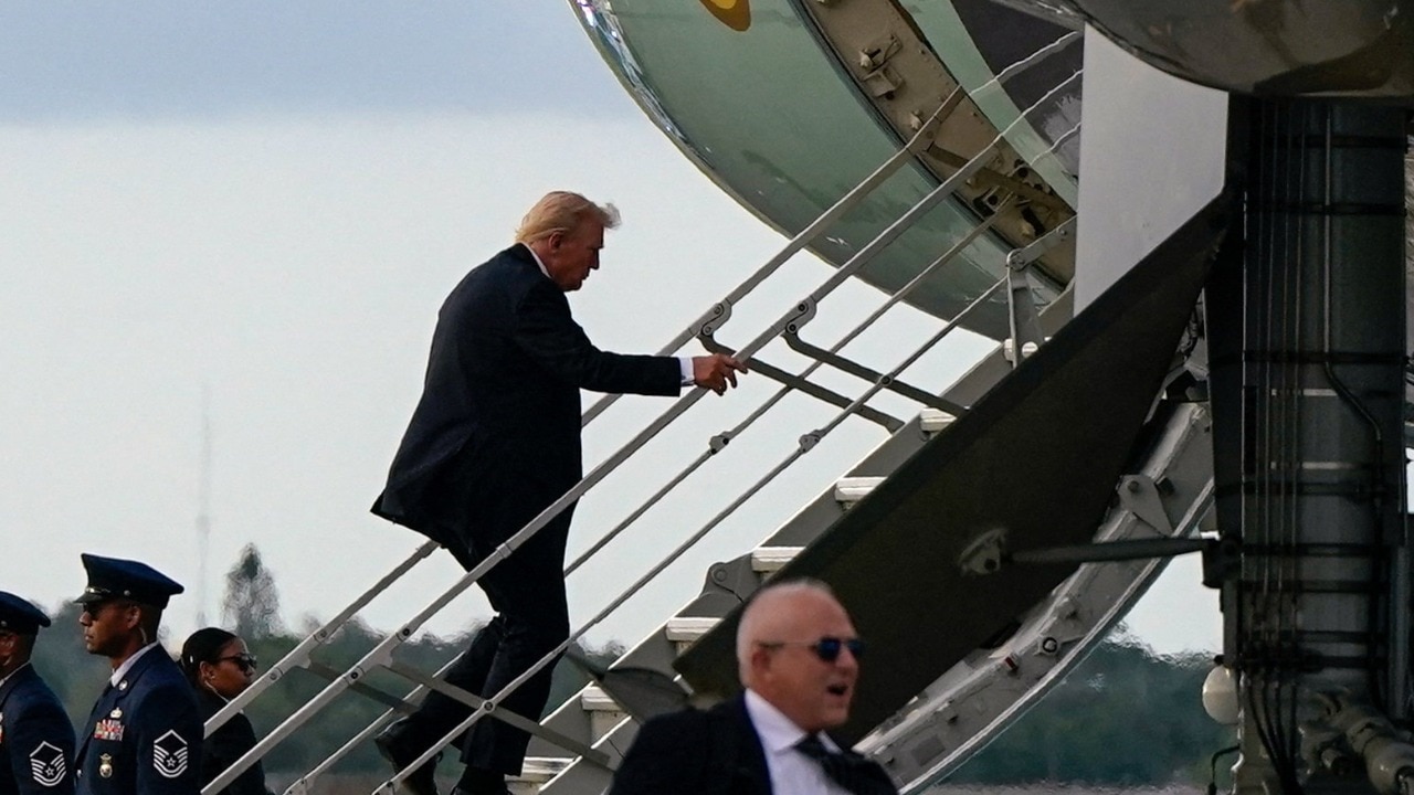 Trump boards Air Force One using small stairs after sniper nest found near airport