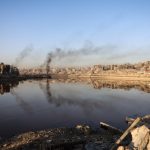 Heavily damaged buildings are reflected in a water basin in the Sheikh Radwan neighborhood of Gaza City on October 22, 2025. [File: Omar Al-Qattaa/AFP]
