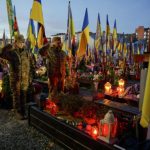 epa12495757 Soldiers salute as they visit the graves of Ukrainian soldiers killed in the armed conflict with Russia at the Lychakiv Cemetery in Lviv, Western Ukraine, 31 October 2025, as Ukrainian Greek Catholics mark All Saints' Day and Day of the Dead amid the ongoing Russian invasion. EPA/MYKOLA TYS