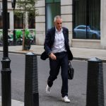 Tim Davie walks outside BBC