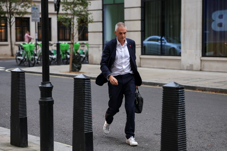 Tim Davie walks outside BBC