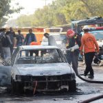 Burned out car at bomb site.