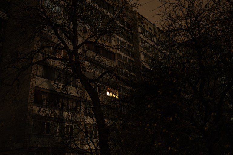 A window with a light on is seen in a residential building during a blackout in Kyiv on November 9, 2025, following Russian missile and drone attacks on Ukrainian energy infrastructure.