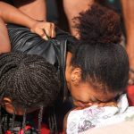 Relatives mourn beside the bodies of people killed the day before during a police raid targeting the Comando Vermelho gang in the Complexo da Penha favela of Rio de Janeiro, Brazil, Wednesday, Oct. 29, 2025. (AP Photo/Silvia Izquierdo)