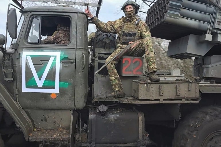 In this image, made from video and provided by Russian Defense Ministry Press Service on Thursday, Nov. 6, 2025, Russian soldiers ride a Tornado-G self-propelled multiple rocket launcher to fire towards Ukrainian positions on an undisclosed location in Ukraine. (Russian Defense Ministry Press Service via AP)