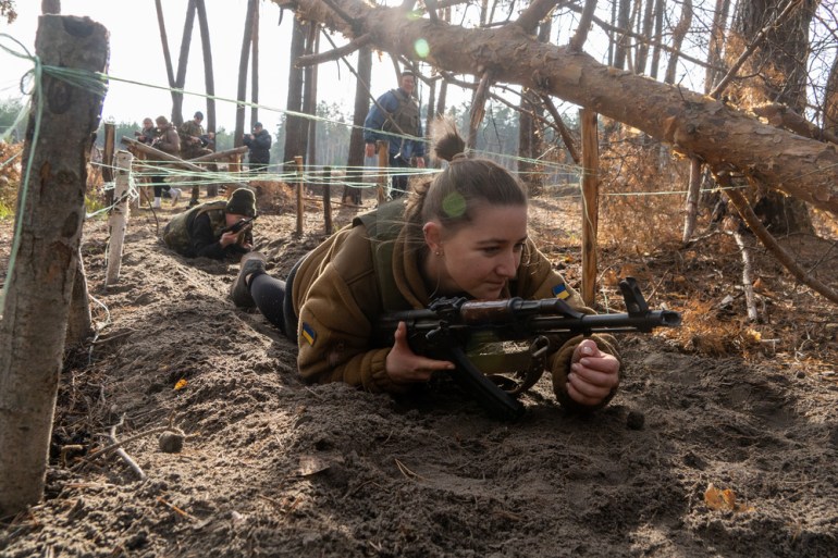 Ukrainian civilians practice on a military training course