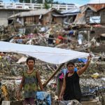 Residents rebuild their damaged houses in the aftermath of Typhoon Kalmaegi in Talisay, in the province of Cebu on November 5, 2025. (Photo by Jam STA ROSA / AFP)