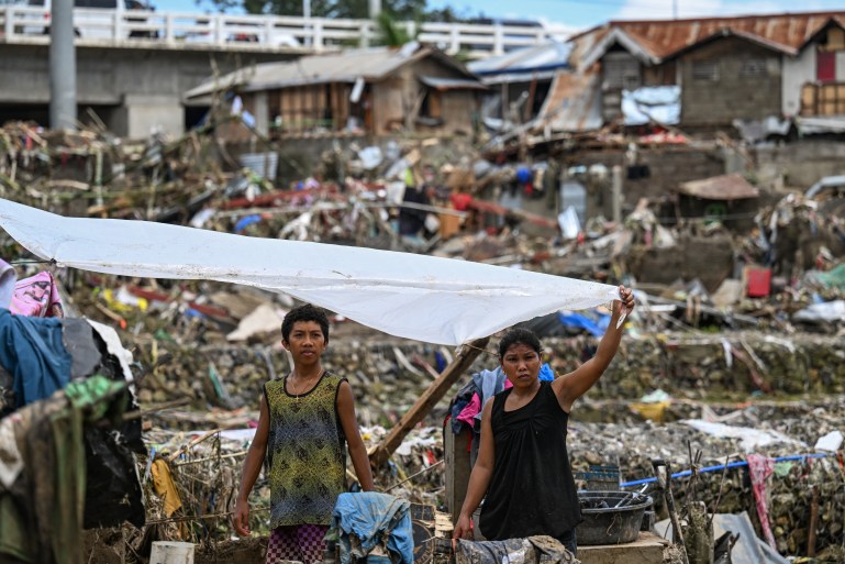 Residents rebuild their damaged houses in the aftermath of Typhoon Kalmaegi in Talisay, in the province of Cebu on November 5, 2025. (Photo by Jam STA ROSA / AFP)