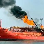 This image released on Monday, Nov. 17, 2025 by Romania's Emergency services, ISU, shot from the Romanian side of the border on the Danube river, shows a cargo ship loaded with liquified petroleum gas engulfed by flames following Russian strikes on Ukrainian port infrastructure in Izmail, Ukraine. (ISU Tulcea via AP)