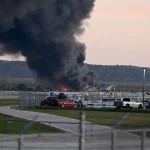 Fire and smoke can be seen, marking where a UPS cargo plane crashed near Louisville Muhammad Ali International Airport